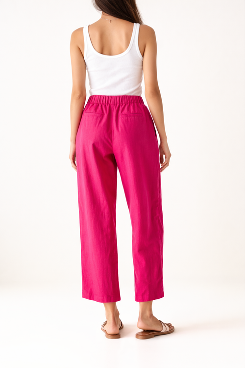 100% cotton fuschia pink elasticated waist & drawstring trousers with pockets in side and back. Drawstring detail