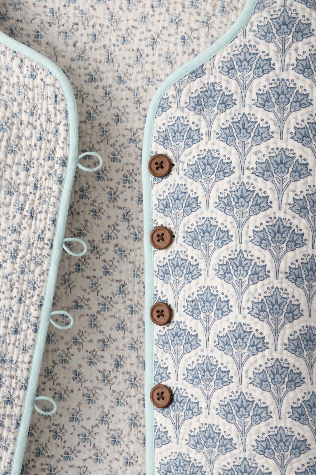 Wood block printed cotton quilted reversible jacket in soft blues.